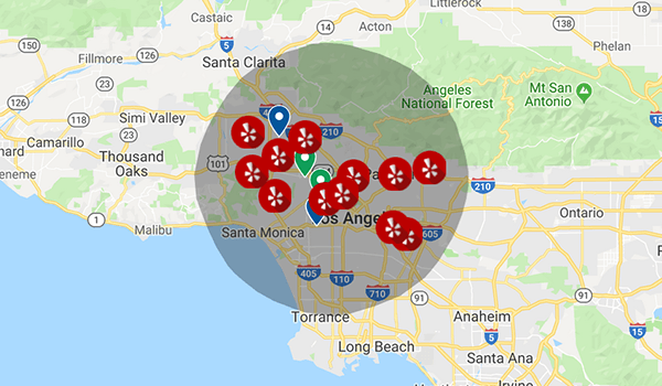 Map showing several red location markers with a Yelp logo around Los Angeles area.